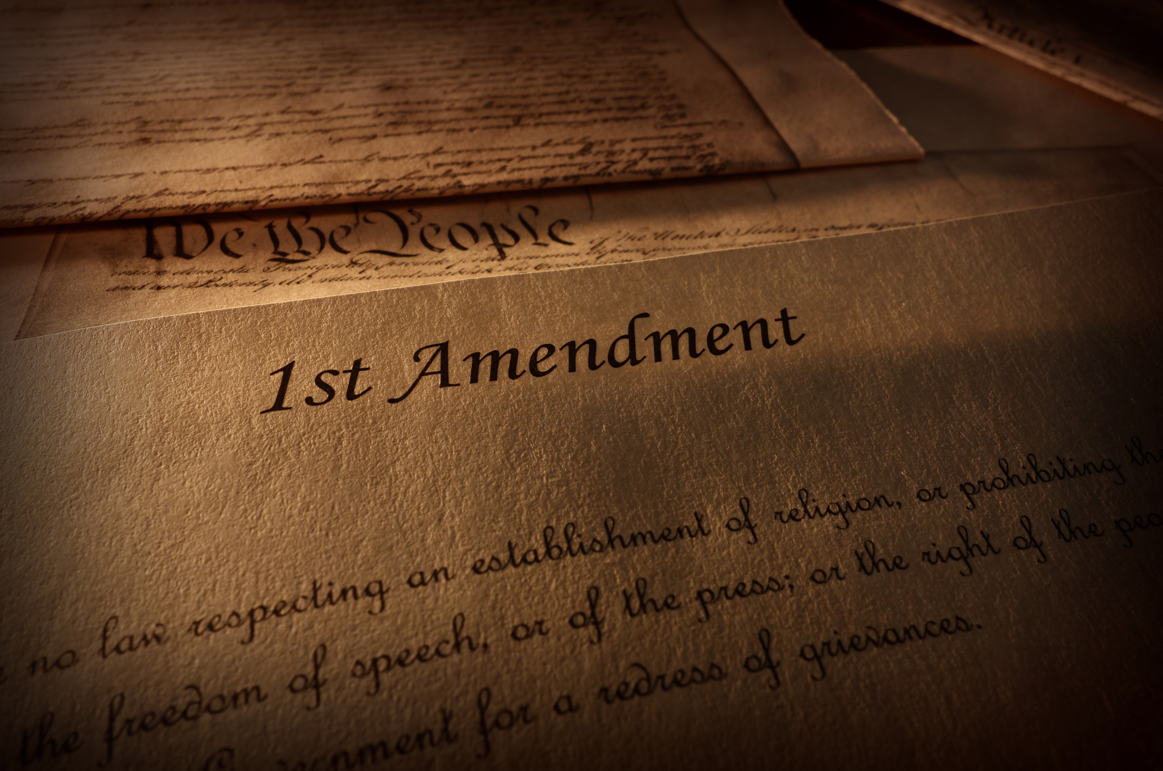 First Amendment of the US Constitution text, with other Constitution text above