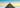 A man standing on top of a dark mountain shape made up of Google logos.