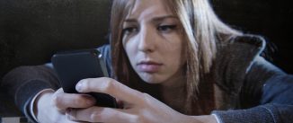 worried woman stares at phone