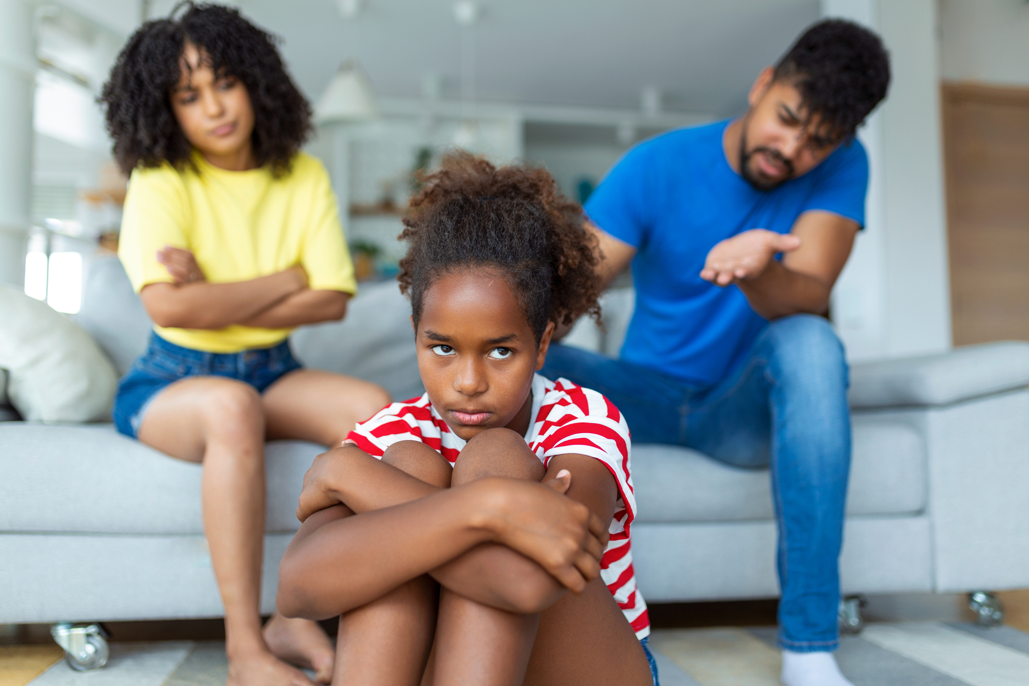 Naughty Kid. Annoyed Parents Scolding Their Little Daughter For Her Behaviour While Sitting Together On Couch At Home