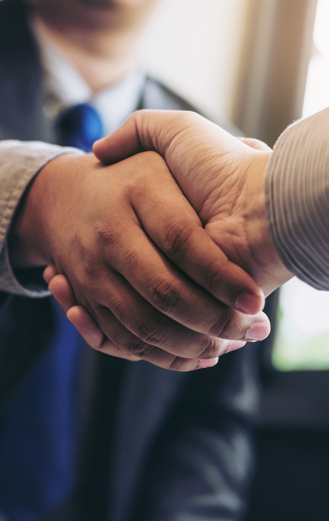 Two business men shaking hands during a meeting to sign agreement and become a business partner, enterprises, companies, confident, success dealing, contract between their firms.