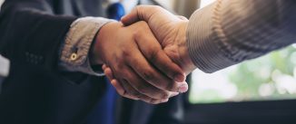 Two business men shaking hands during a meeting to sign agreement and become a business partner, enterprises, companies, confident, success dealing, contract between their firms.