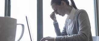 worried woman looking at computer