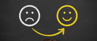 Unhappy and Happy over Human Head on Blackboard