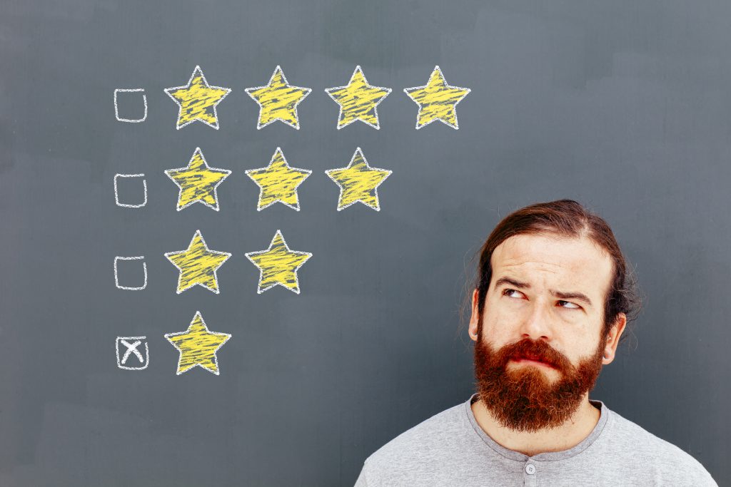 Bearded man looking up at star ratings