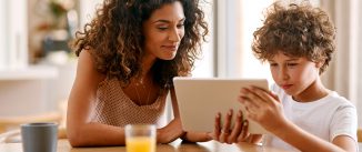 Shot of a young woman and her son using a digital tablet together in the morning at home