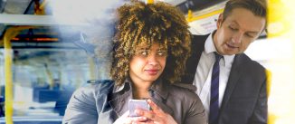 Man looking over a woman's shoulder at her phone on public transit.