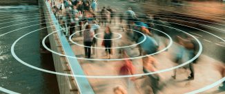 A woman in a crowd on a bridge is targeted by concentric circles