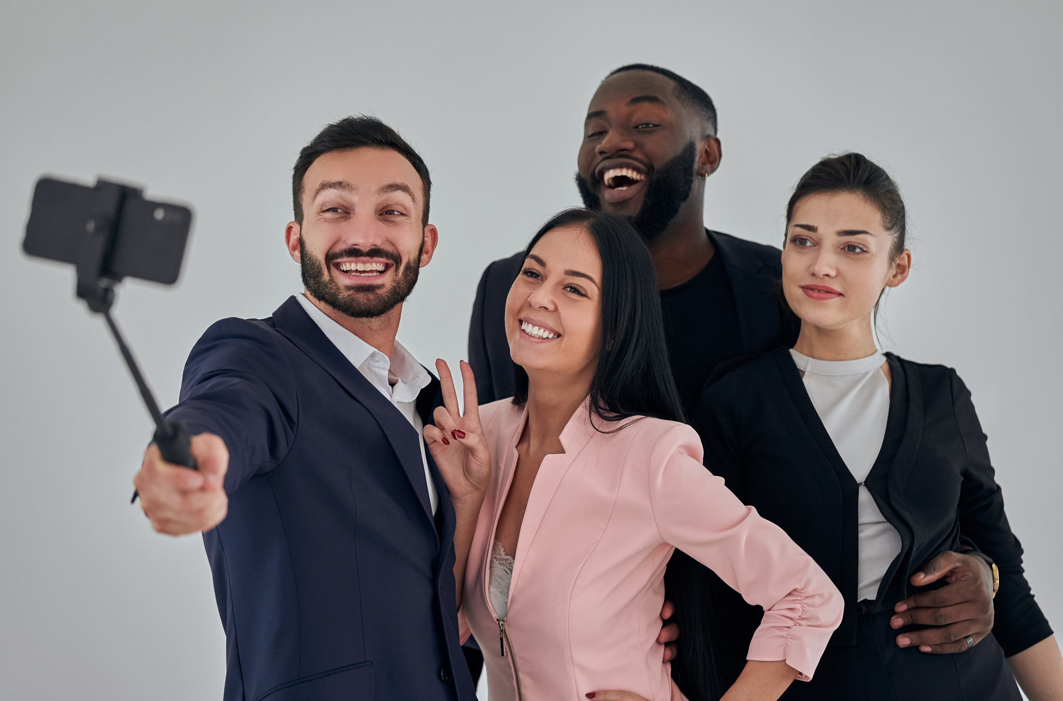 The four happy business people making selfie