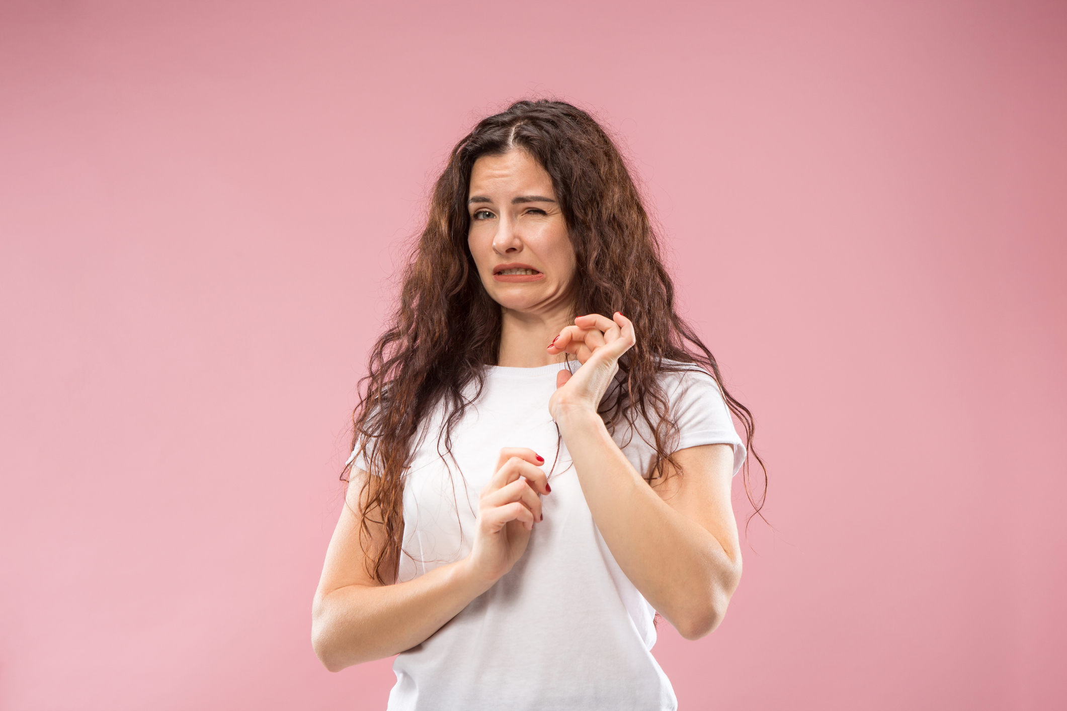 Ew. It's so gross. Young woman with disgusted expression repulsing something. Disgust concept. Young emotional woman. Human emotions, facial expression concept. Studio. Isolated on trendy pink color