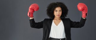 Business woman in red boxing gloves.