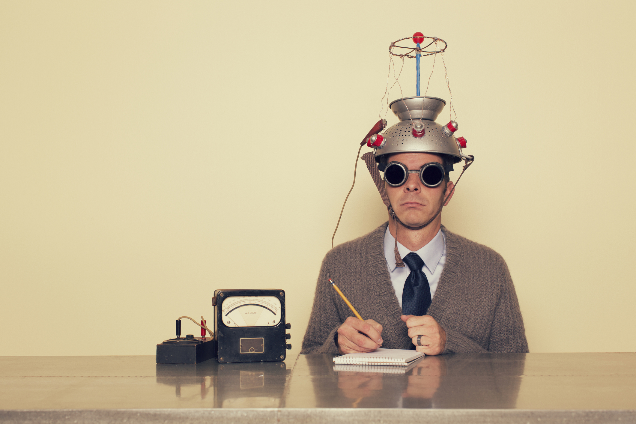 Man testing his brain with scientific helmet..