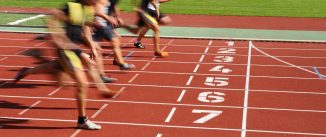 Runners racing on a numbered track