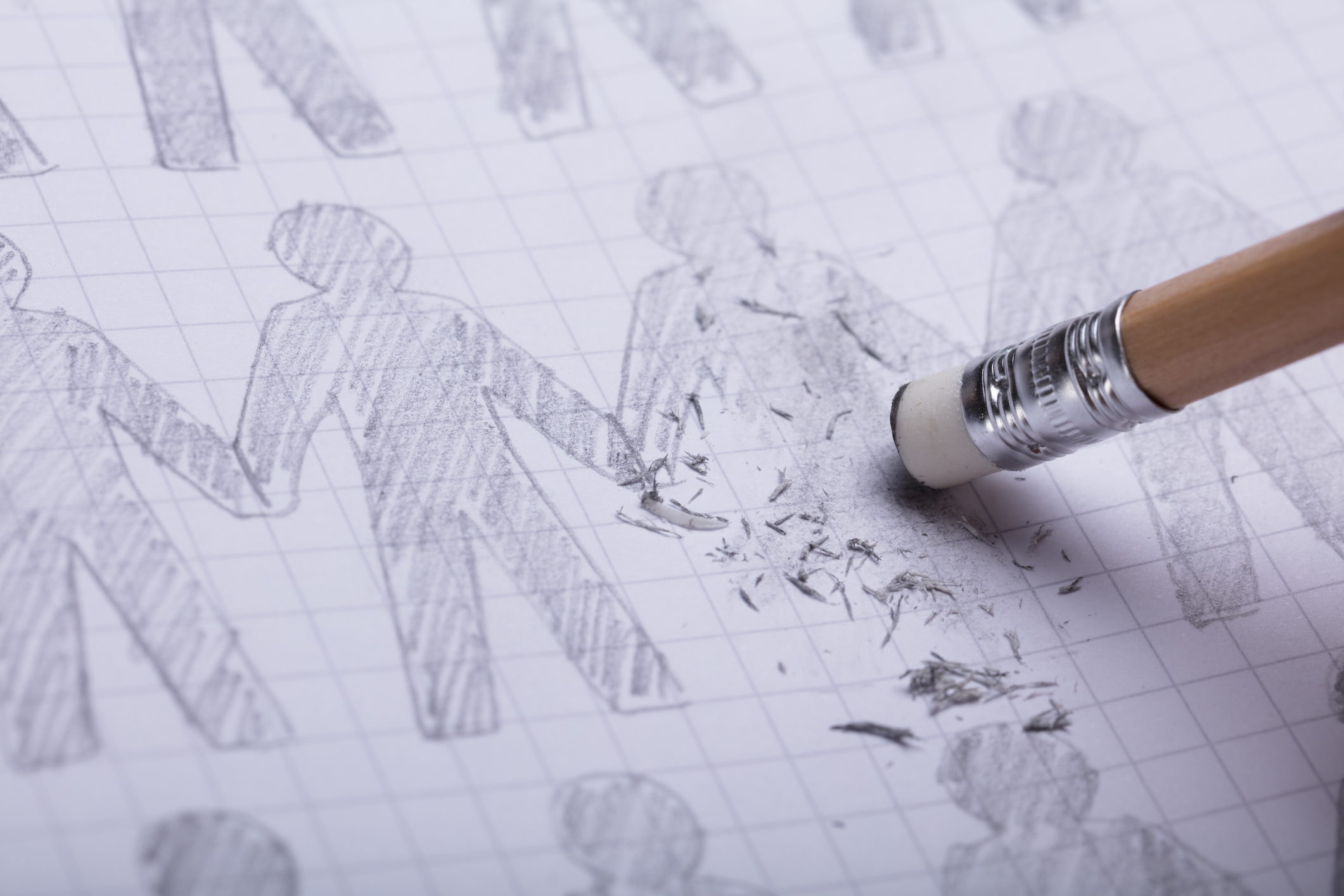 Close-up Of Pencil Eraser Erasing Drawn Figures On Paper