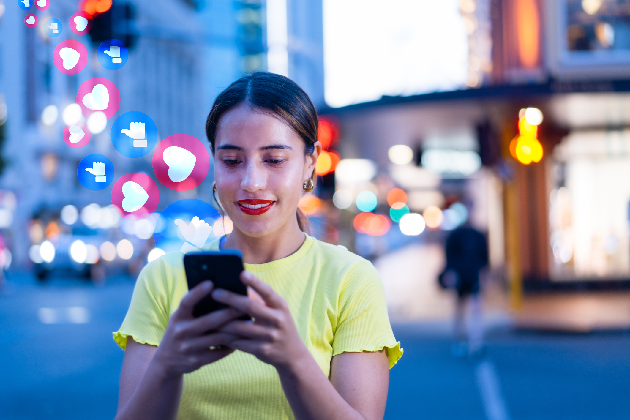 Woman on her phone checking the social media in city with city lights in background.