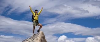 Hiker celebrates on the summit.