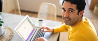 Portrait of a mid adult man using the laptop at home