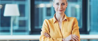 Smiling businesswoman standing in the office